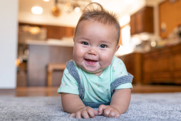 Baby lying on carpet floor | Staff Carpet